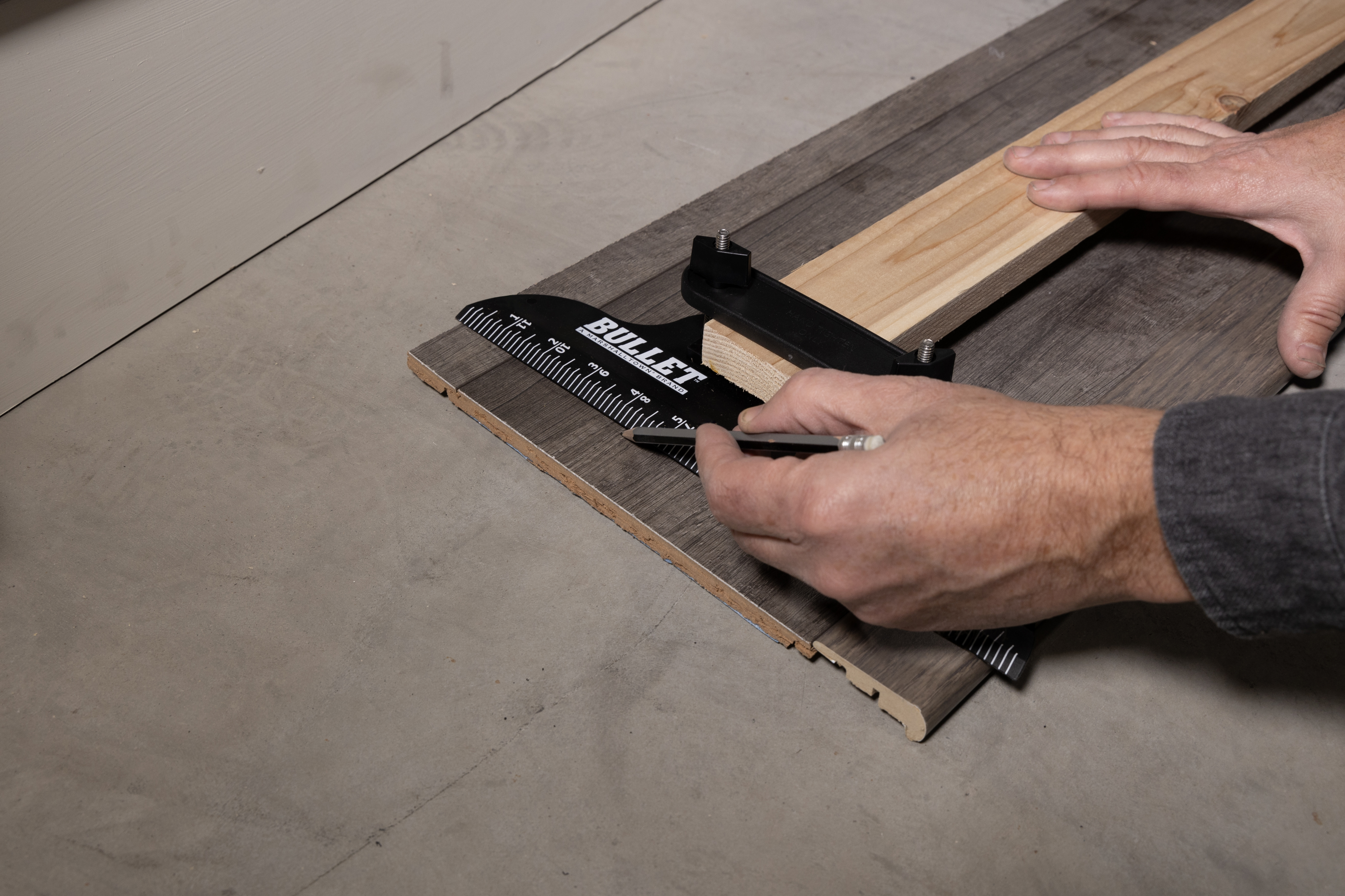 person using lining up the stair tread tool to cut the tread
